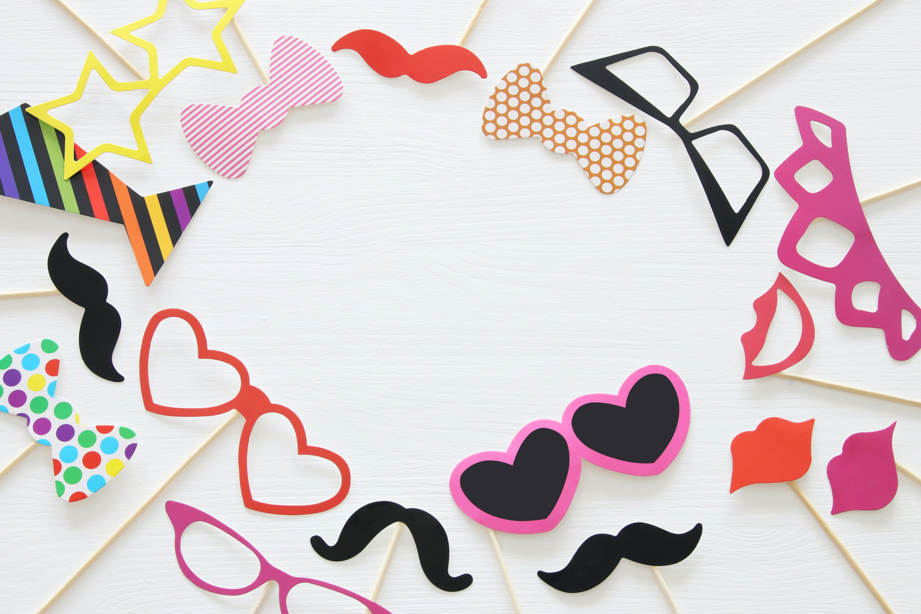 Top view image of funny and colorful photo booth props for party over white background.